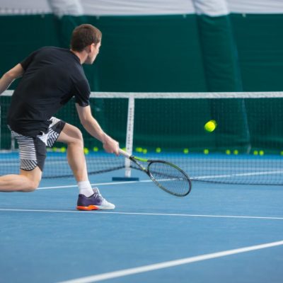 the-young-man-in-a-closed-tennis-court-with-ball.jpg