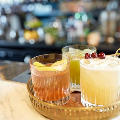 tray with glasses of cocktails at bar